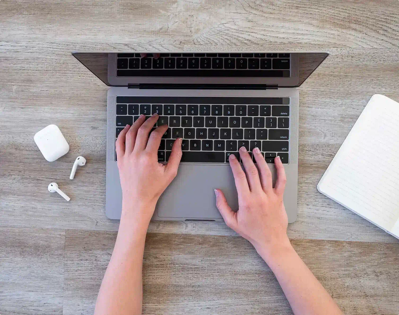Hands typing on computer